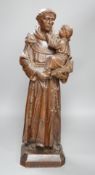 An early 20th century carved oak figure of St Anthony, 51cm