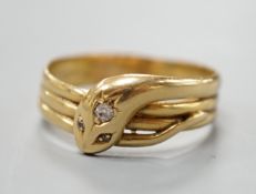 An Edwardian 18ct gold and diamond chip set serpent ring, size X/Y, gross 5.6 grams.