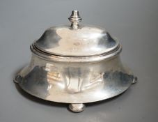 An early 20th century silver oval box, with hinged cover, on bun feet marks rubbed, length 18.5cm,