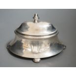 An early 20th century silver oval box, with hinged cover, on bun feet marks rubbed, length 18.5cm,