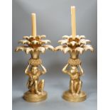 A pair of gilt resin ‘monkey and pineapple’ candlesticks. 37cm tall