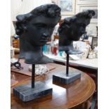 A pair of bronze masks of youths, raised on marble plinths,78cms high,
