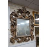 An 18th / 19th century Florentine style carved gilt gesso wall mirror, width 85cm, height 116cm