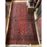 A Belouch red ground rug, 195 x 106cm