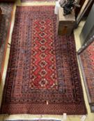 A Belouch red ground rug, 195 x 106cm