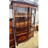 An early 20th century George III style satinwood banded mahogany inlaid bow front display cabinet,