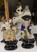 Five Staffordshire pottery figures or groups, tallest 36 cm high two similar Toby jugs, a pair of