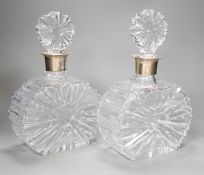 A pair of silver collared cut glass decanters. 27cm high.