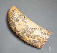 A 19th century scrimshaw erotic carved sperm whale tooth, 14cm long.