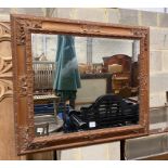 A Continental rectangular carved wood wall mirror, width 198cm, height 82cm and a small circular