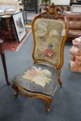 A Victorian carved walnut nursing chair with floral embroidered upholstery, height 112cm
