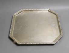 A George V silver octagonal salver, on swept feet, with engraved border, Goldsmiths & Silversmiths
