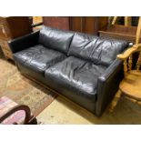 A black leather upholstered two seater sofa bed, length 172cm
