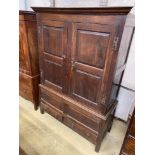 A mid 18th century oak press cupboard with two panelled doors and two drawers