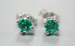 A pair of 750 white metal and solitaire emerald set ear studs, gross weight 1.5 grams, stone