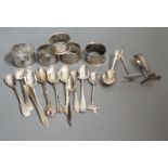 A miscellaneous collection of small silver items to include napkin rings, spoons, etc.