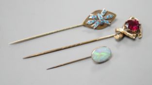 Three various base metal stick pins, one set with white opal doublet?, 45mm.