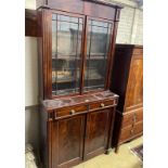 A Regency mahogany bookcase / cupboard, width 106cm, depth 44cm, height 226cm