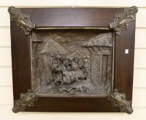 A framed spelter relief plaque, of the Mongols in battle, 59cm wide 51cm high, including frame