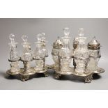 A graduated pair of William IV silver cruet stands, with ornate scroll handles, by John Fry II,