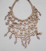An Indian white metal (tests as 900 standard) filigree fringe necklace, decorated with peacocks,
