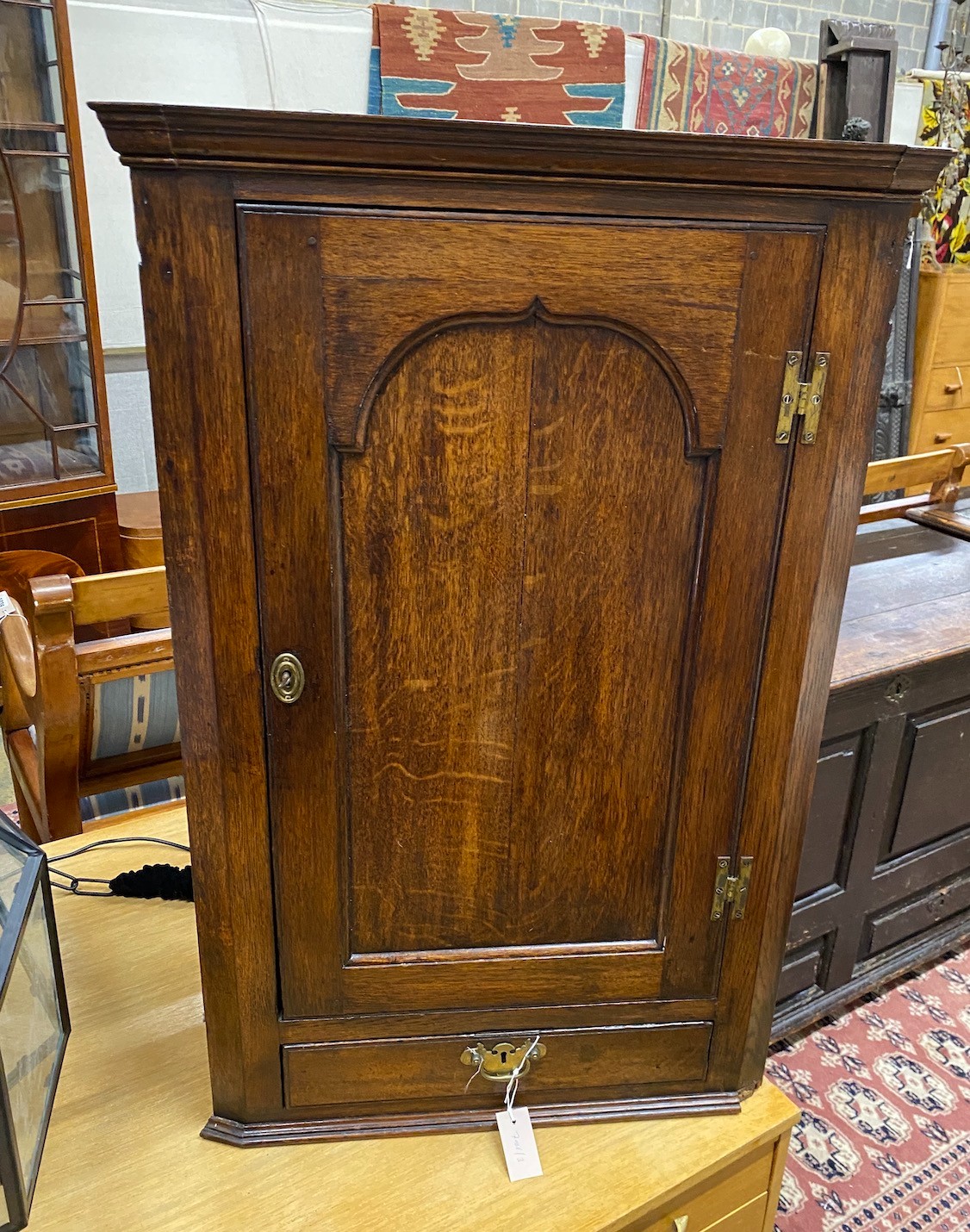 A George III oak hanging corner cabinet, width 62cm, depth 33cm, height 101cm