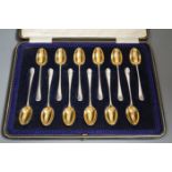 A cased set of twelve late Victorian silver 'picture back' coffee spoons, by Thomas Bradbury & Sons,
