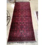 A Bokhara style red ground rug, 196 x 81cm