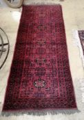 A Bokhara style red ground rug, 196 x 81cm