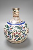 A Continental pottery bottle vase, in Iznik style, ground down with white metal mount. 20cm tall.