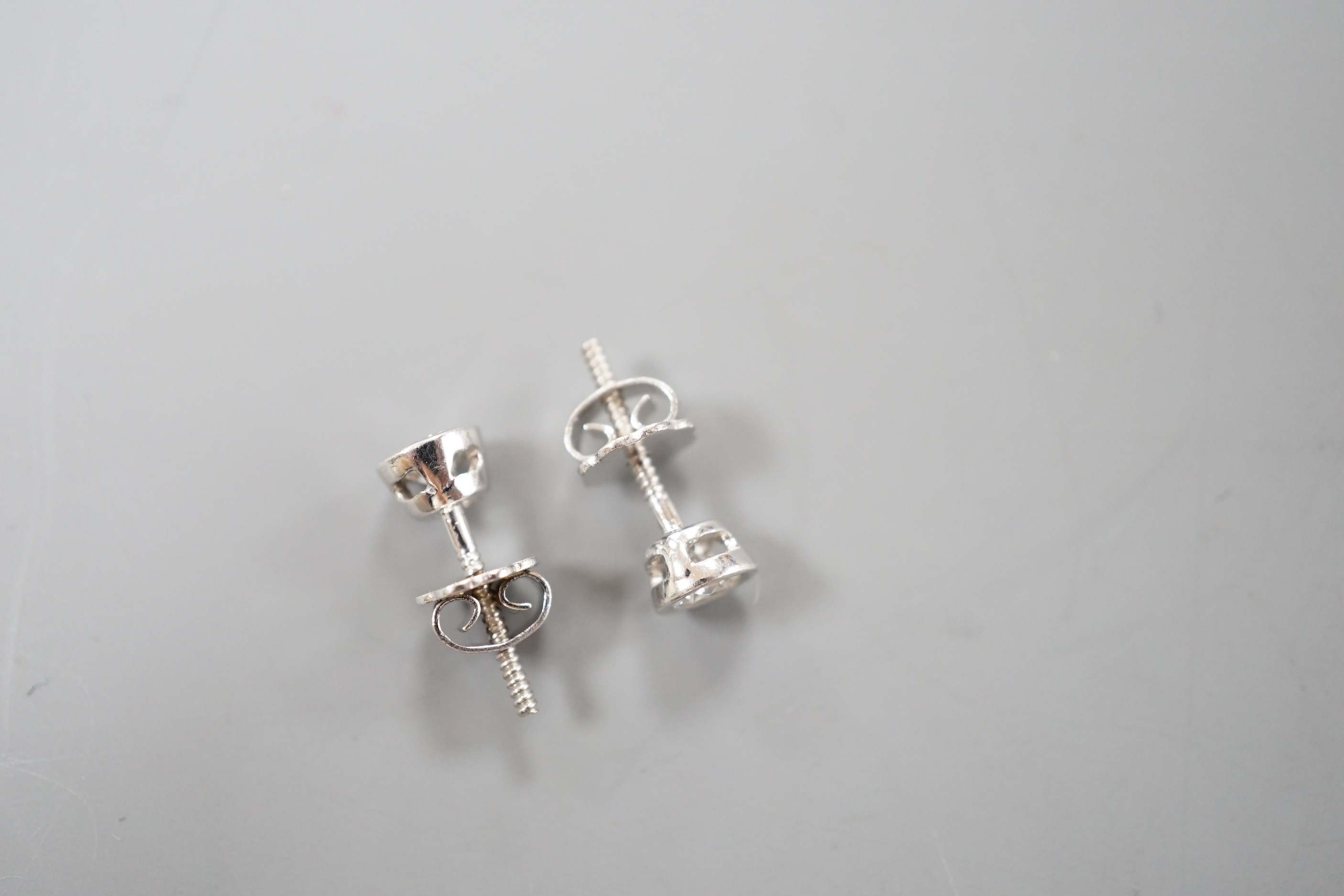 A pair of 750 white metal and collet set solitaire diamond ear studs, gross weight 1.5 grams, - Image 4 of 4