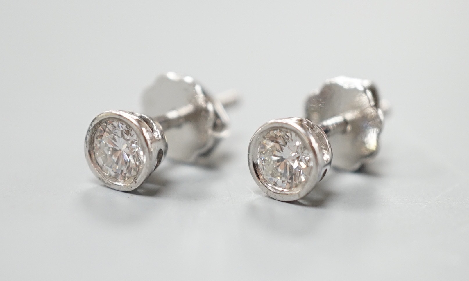 A pair of 750 white metal and collet set solitaire diamond ear studs, gross weight 1.5 grams, - Image 2 of 4