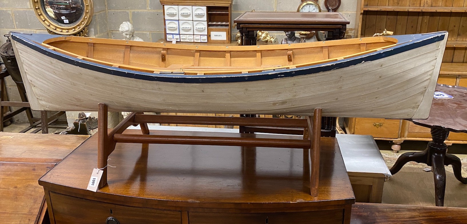 A model clinker built rowing boat with oars and stand, length 150cm