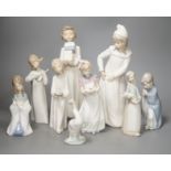 Seven Lladro figures together with two Nao figures. Tallest 29cm