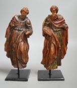 A pair of 17th century carved and painted pine figures. Tallest 26cm