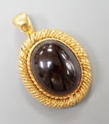 A yellow metal and oval foil backed? cabochon garnet set pendant, with close back setting, overall