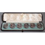 A cased set six late Victorian pierced silver dress buttons, depicting a gentleman wearing a toga,