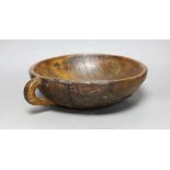 A carved elm mazer bowl, with old blacksmith repair, 31cm diameter