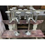 A pair of Meuker five branch chrome plated candlesticks, height 85cm