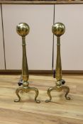 A pair of brass andirons. 57cm high