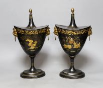 A pair of Japanned toleware urns and covers, 33cm tall