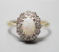 A modern 18ct gold, white opal and diamond chip set oval cluster ring, size N, gross weight 3.6