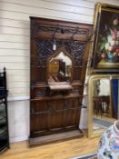 An early 20th century gothic revival wrought iron and rouge marble mounted carved mahogany hall