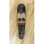 An African carved and painted wood mask. 64cm long