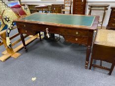 An early 20th century French mahogany kneehole writing table on fluted legs width 144cm, depth 71cm,