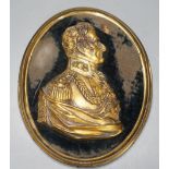 A gilt metal portrait profile relief, The Duke of Wellington, set on black velvet ground, brass