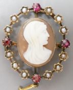 An Edwardian yellow metal, split pearl and ruby mounted oval cameo shell pendant brooch, 32mm, gross