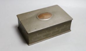 A Tudric planished pewter cigarette box with copper cartouche, 20cm