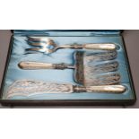 A cased ornate French white metal and mother of pearl mounted serving set, comprising a pair of fish