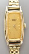A lady's steel and gold plated Seiko quartz wrist watch, on an 18ct gold bracelet, gross weight 16.7